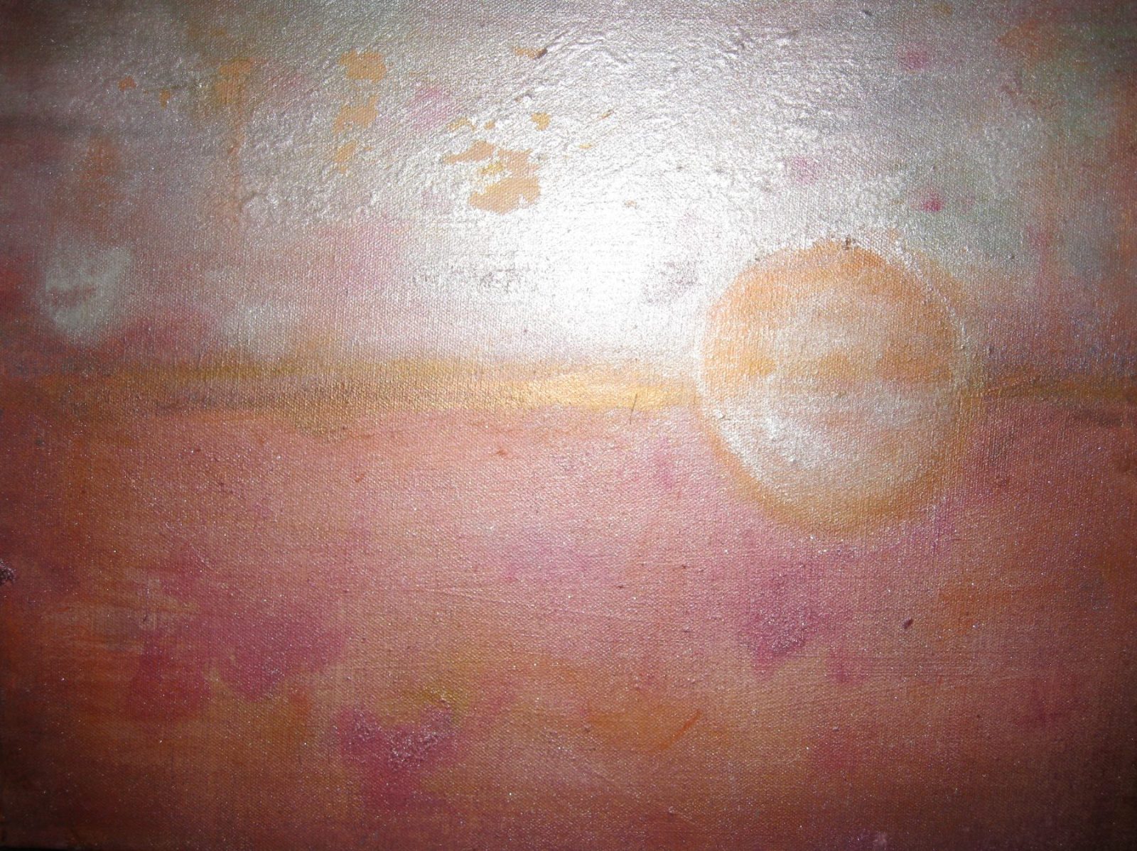 A pale, silvery sun low over a soft rose-and-gold horizon.