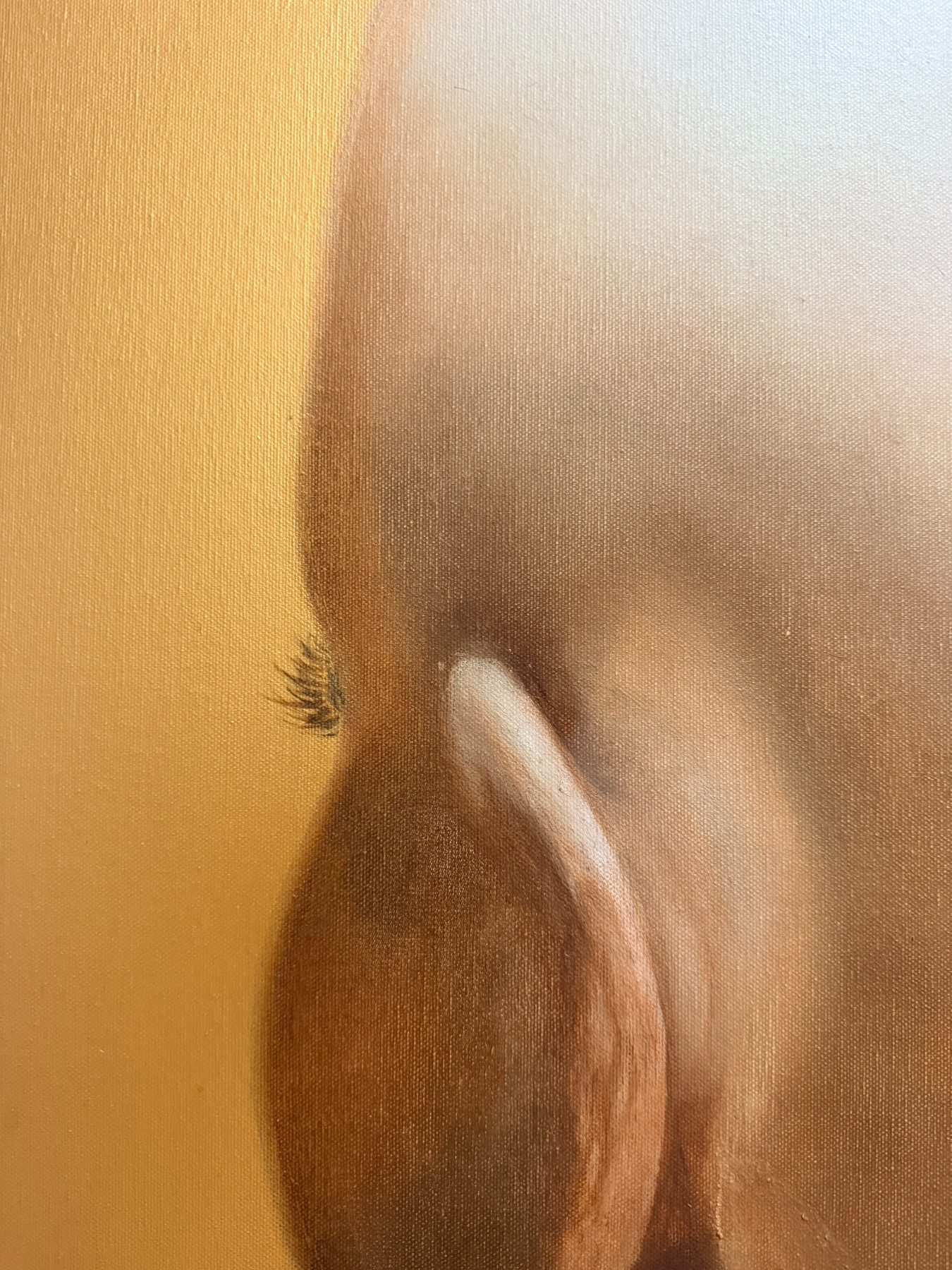 A head seen from behind in close view, the pale curve of an ear against warm skin, a fan of dark lashes just visible past the edge of the face, against a gold ground.
