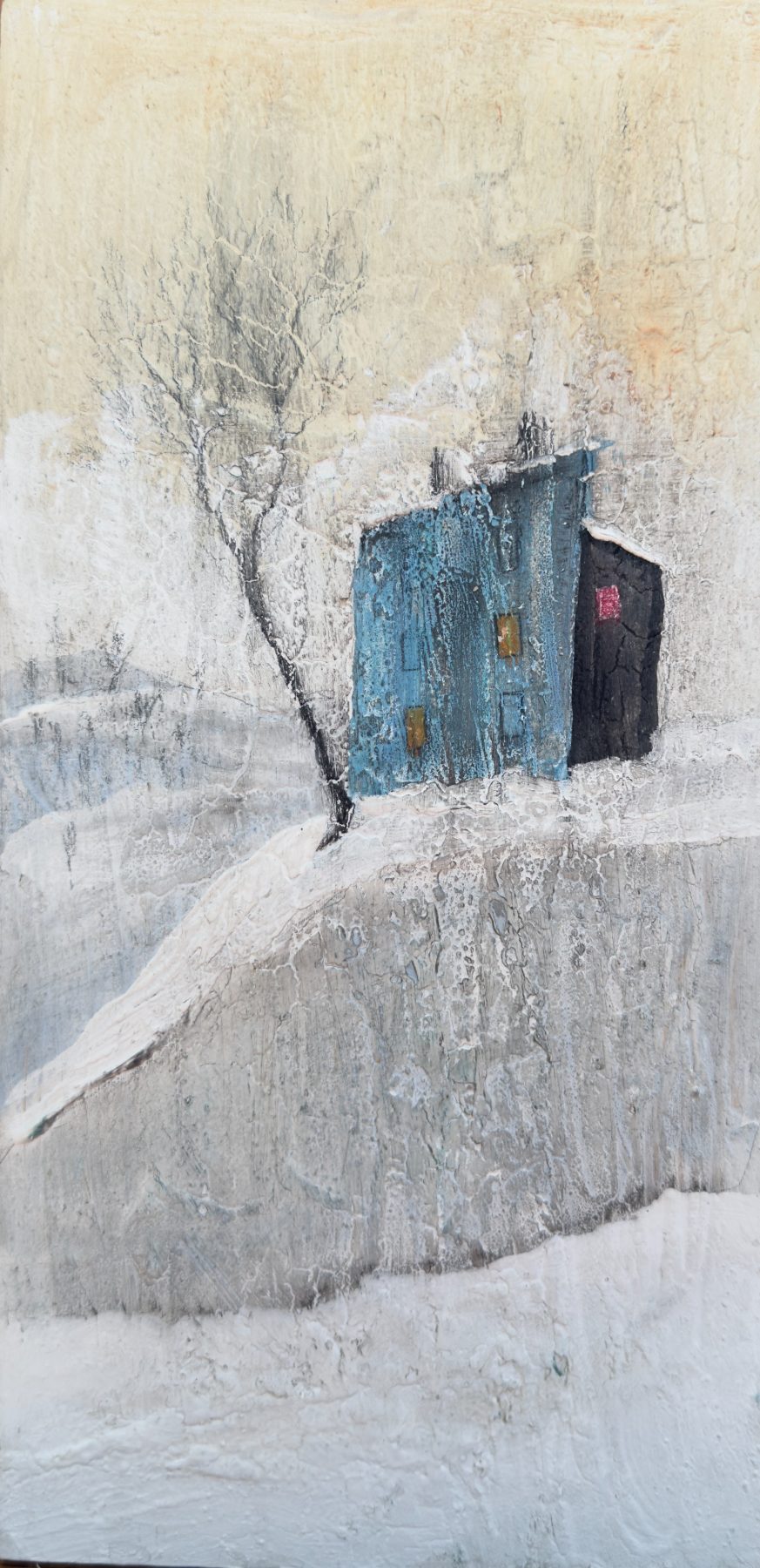 A small weathered blue house and a bare tree on a pale, snow-washed hillside, in textured mixed media.