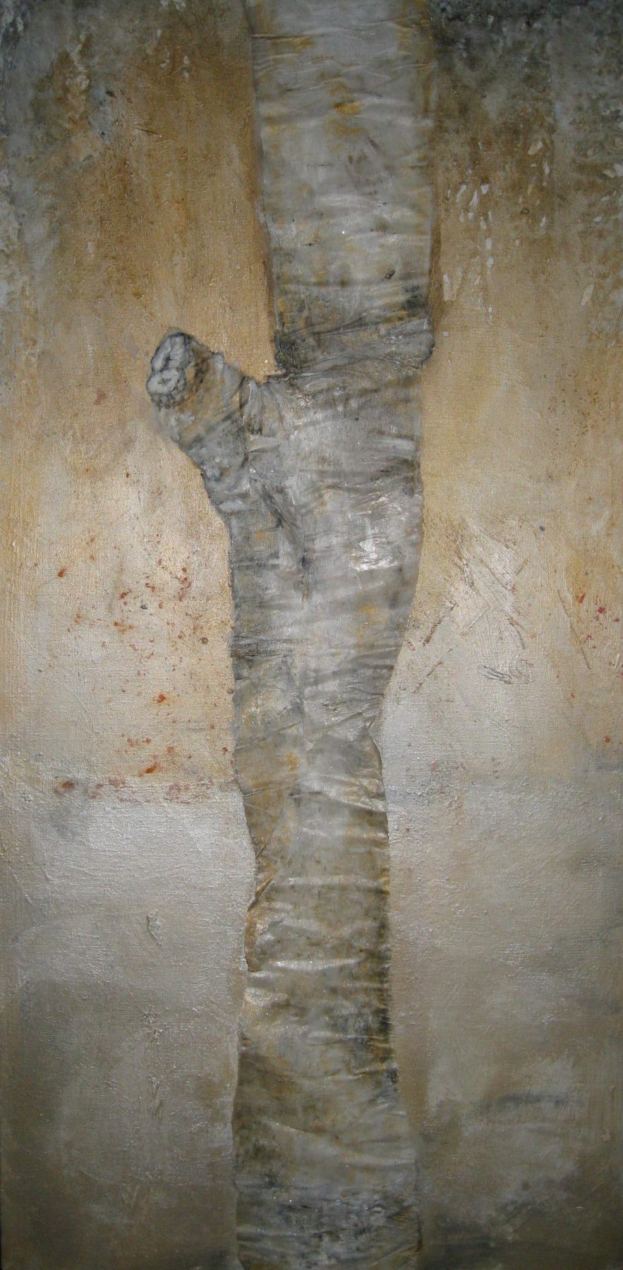 A tall mixed-media work in which pale bark and a wrapped human form seem to merge, in weathered grey and ochre.